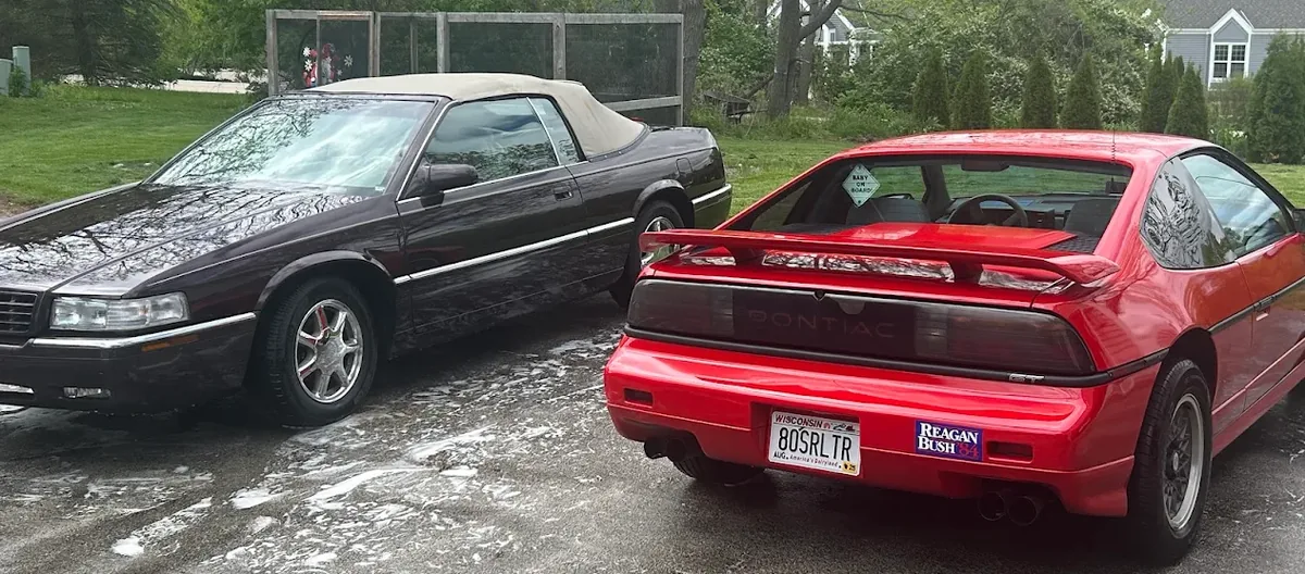 Two freshly detailed cars in a driveway — mobile detailing at home